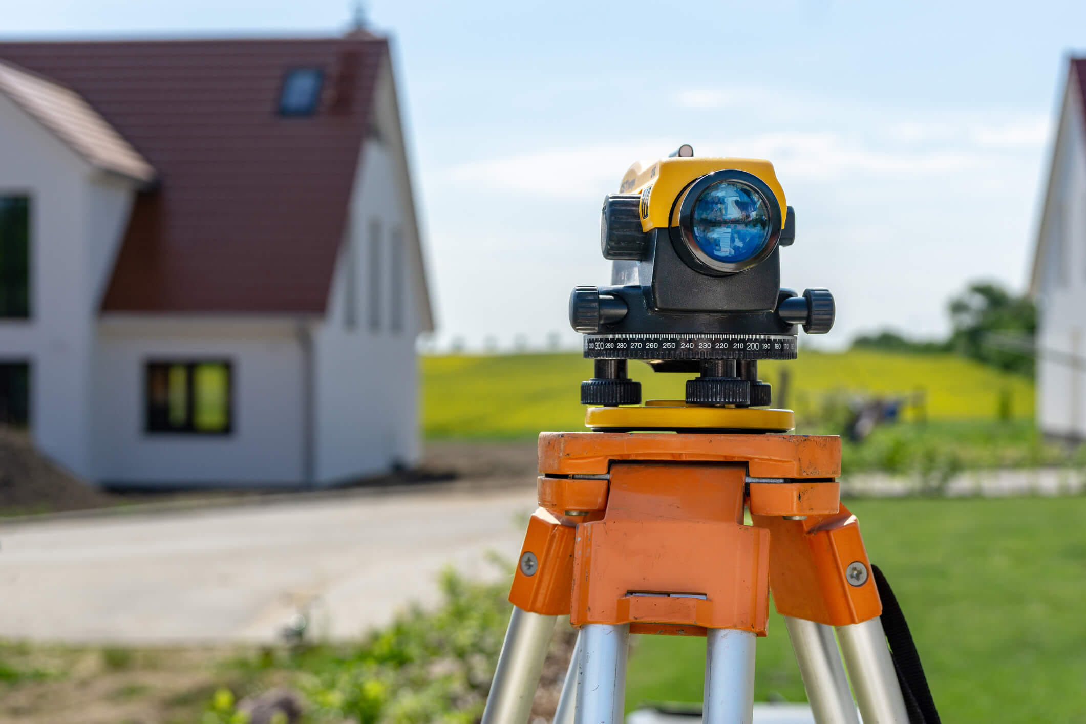 Theodolite on tripod on yard. A theodolite on a yard for a land survey.